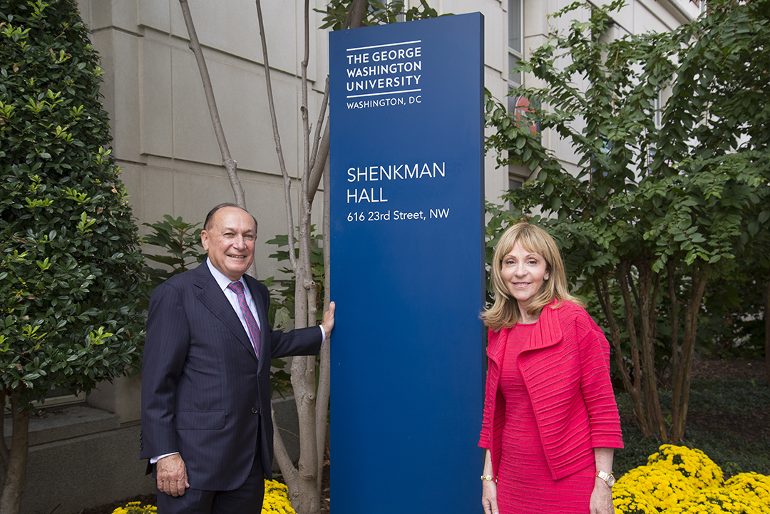 Alumnus Mark Shenkman and his wife, Rosalind, stand outside of his namesake residence hall on the Foggy Bottom campus.