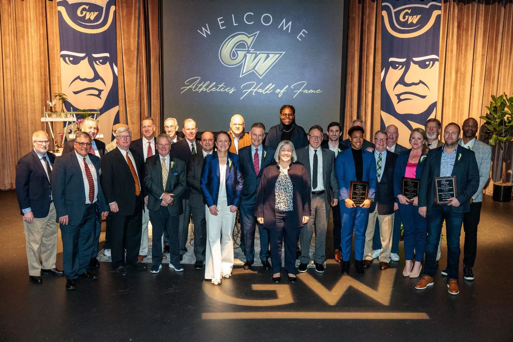 Members of the GW Athletics Hall of Fame Class of 2024 with Athletic Director Tanya Vogel and President Ellen M. Granberg.