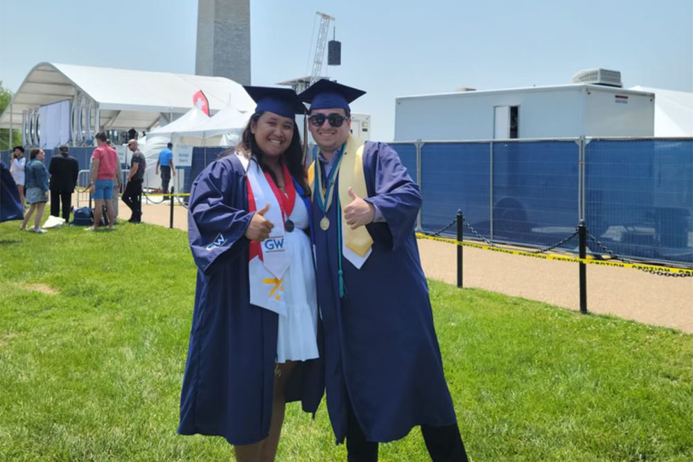 Jason Wyman and Denise Dimapilis on the National Mall in their graduation regalia