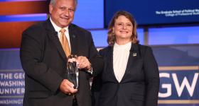 U.S. Navy Secretary Carlos Del Toro accepts the GSPM Alumni Lifetime Achievement Award presented by CPS Dean Liesl Riddle. (Lily Speredelozzi/GW Today)